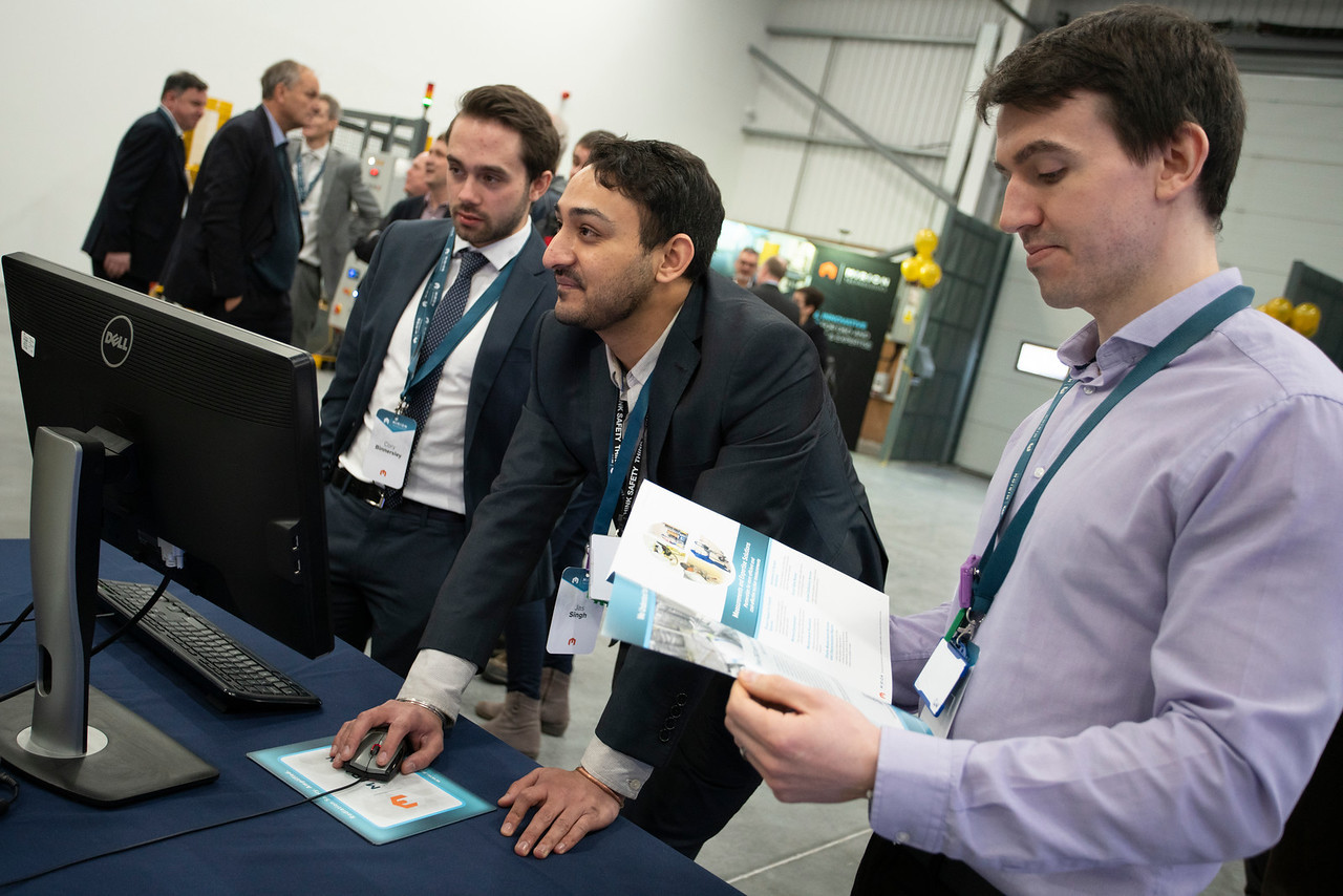 Cory Binnersley (left) and Gareth White (right), being shown our Passive and Active Neutron plus Gamma system by Jas Singh (center), during the recent opening of our new facility in Warrington.